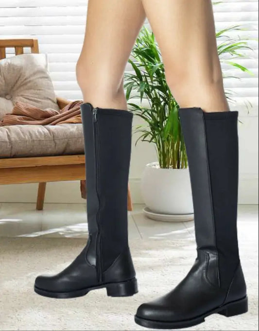 Black leather knee-high boots with elastic side panels and a side zipper.