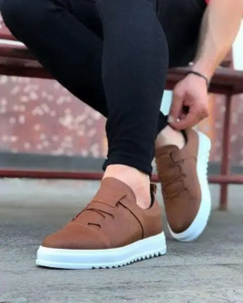 Brown leather sneaker with velcro straps and white platform sole.