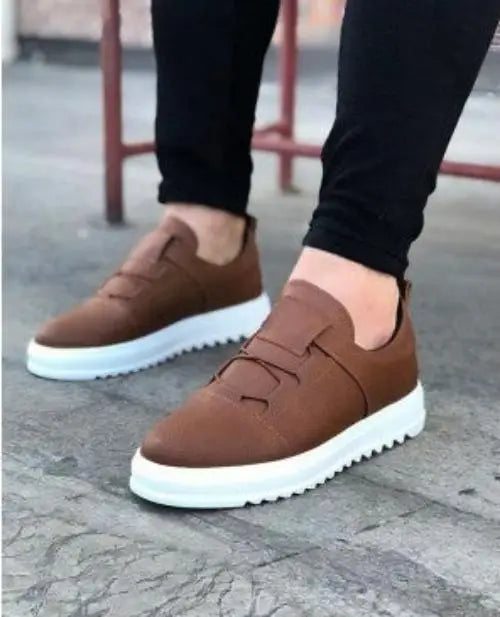 Brown leather slip-on sneakers with white platform soles.